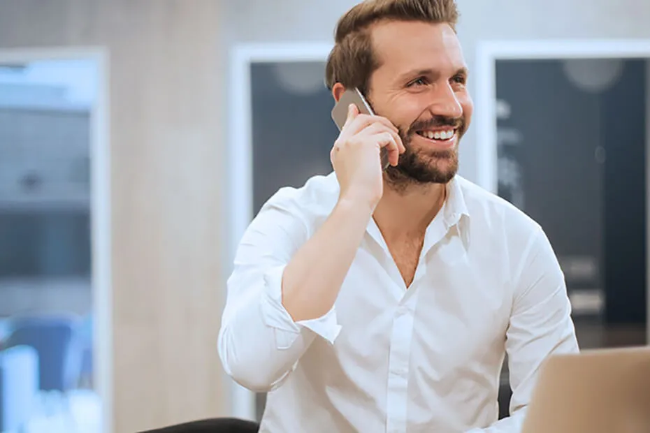 Man Holding Mobile Phone - Talking and Relationships Still Earn Dollars - Epoch Online